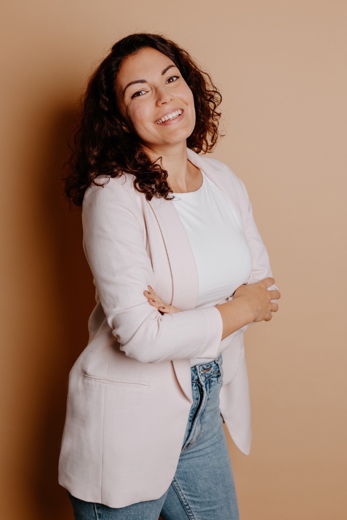 Jennifer Pesta, certified psychological astrologer, smiling at the camera
